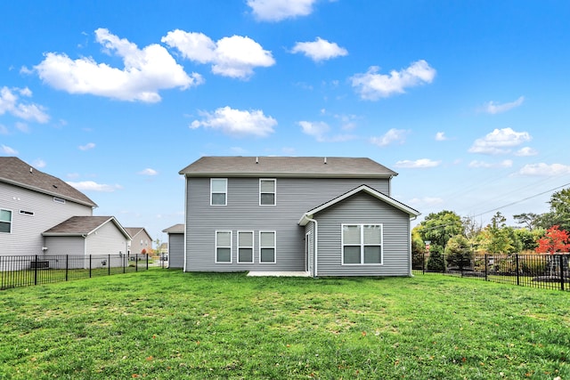 rear view of property with a lawn