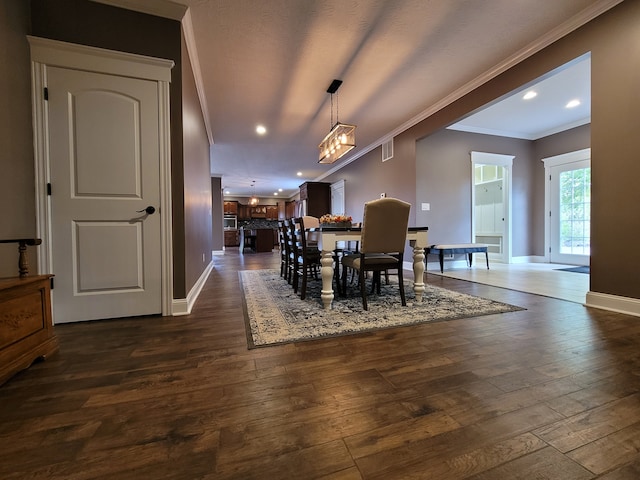 dining area with crown molding and dark hardwood / wood-style floors