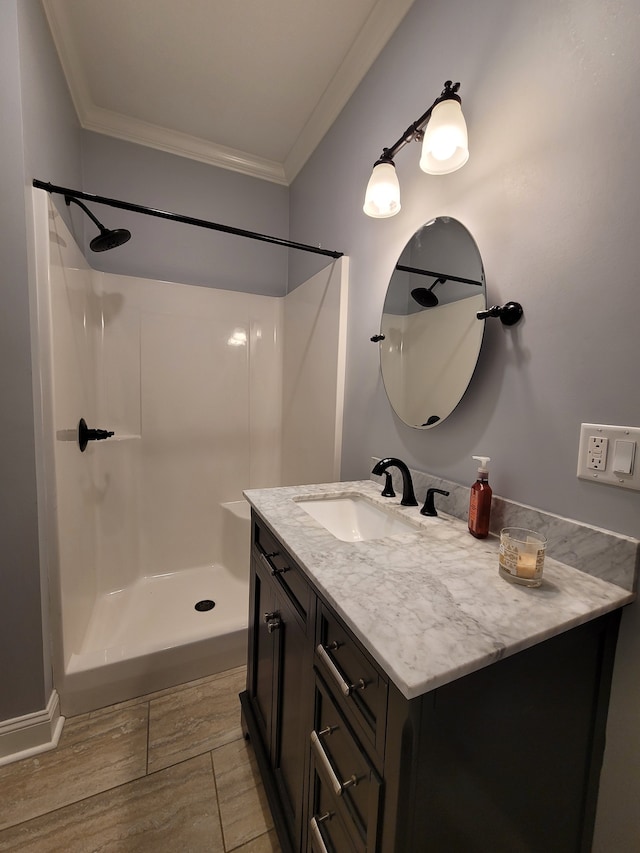 bathroom with vanity, hardwood / wood-style flooring, walk in shower, and ornamental molding