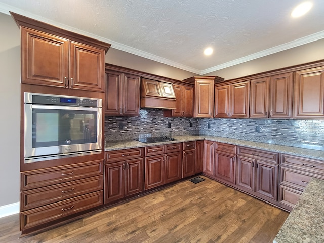 kitchen featuring decorative backsplash, stainless steel oven, dark wood-type flooring, crown molding, and black stovetop