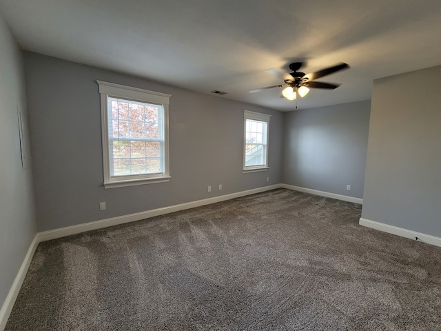 carpeted spare room with ceiling fan and plenty of natural light