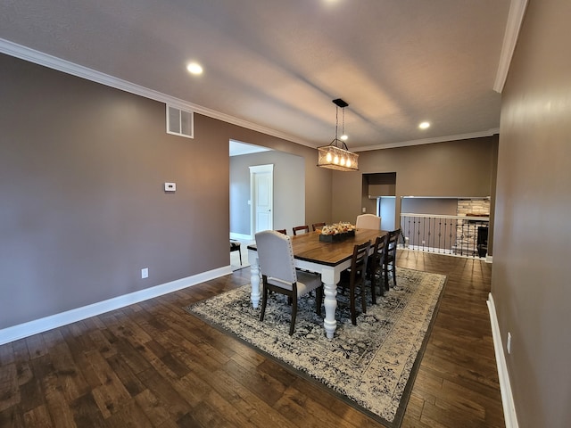 dining space featuring crown molding and dark hardwood / wood-style flooring