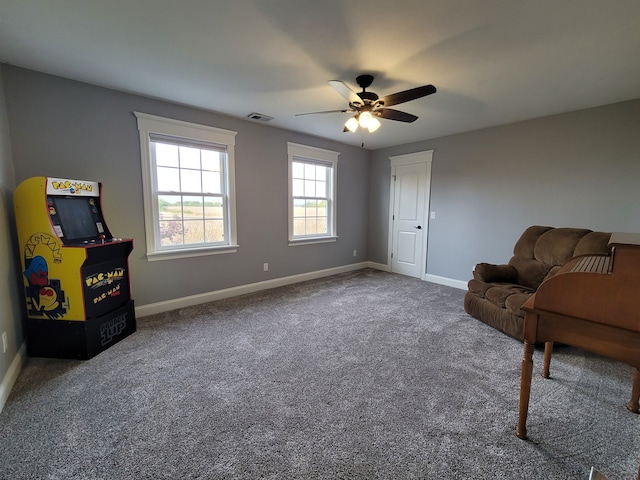 living area featuring carpet and ceiling fan