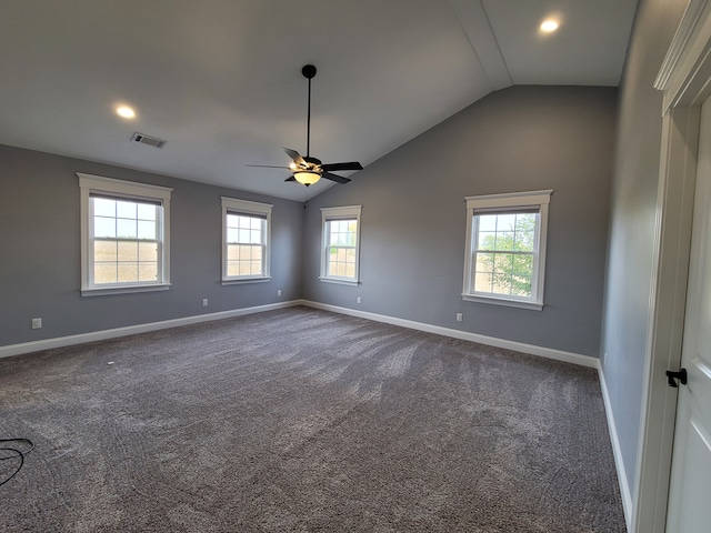 unfurnished room with dark carpet, vaulted ceiling, and ceiling fan