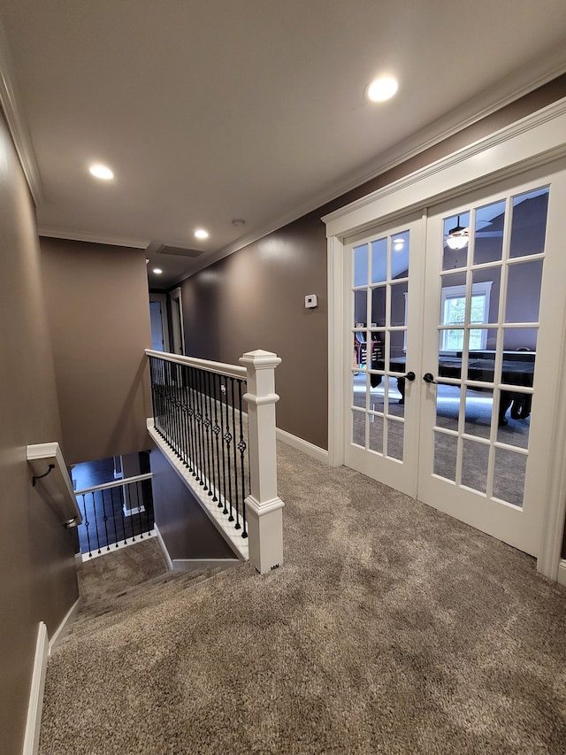 staircase with crown molding, french doors, and carpet