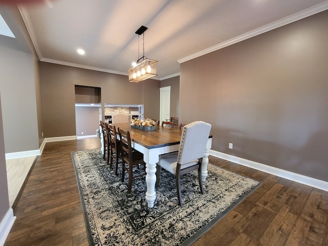 dining space featuring crown molding and dark hardwood / wood-style floors