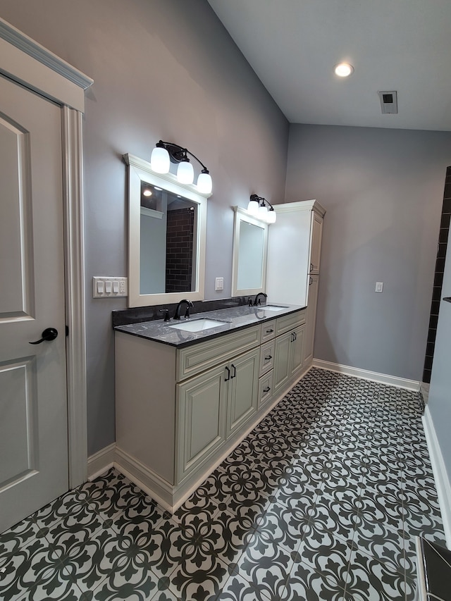 bathroom with vanity and lofted ceiling