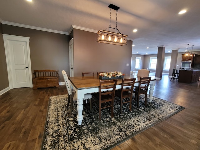 dining space featuring ornamental molding and dark hardwood / wood-style flooring