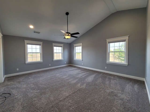 unfurnished room with ceiling fan, lofted ceiling, and dark carpet