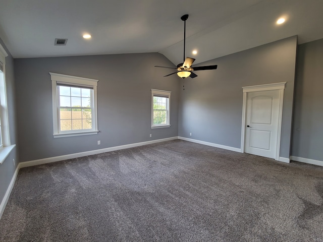 unfurnished room featuring ceiling fan, vaulted ceiling, and dark carpet