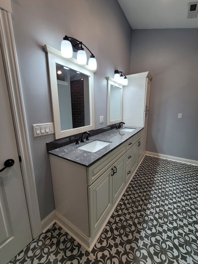 bathroom with vanity and lofted ceiling