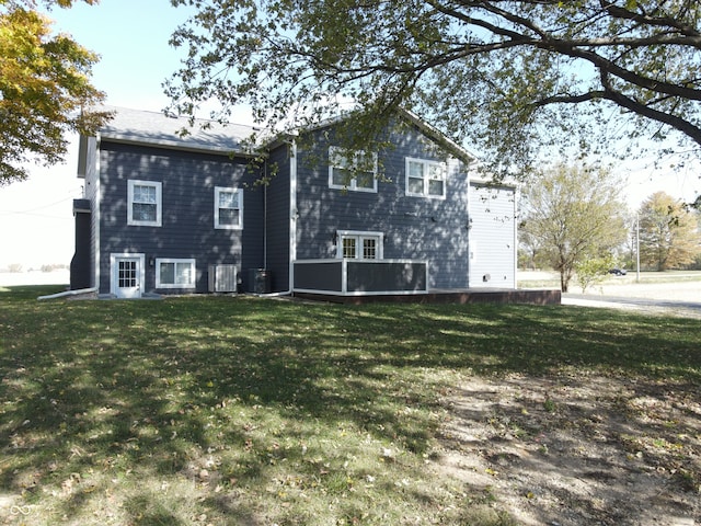 rear view of house featuring a yard