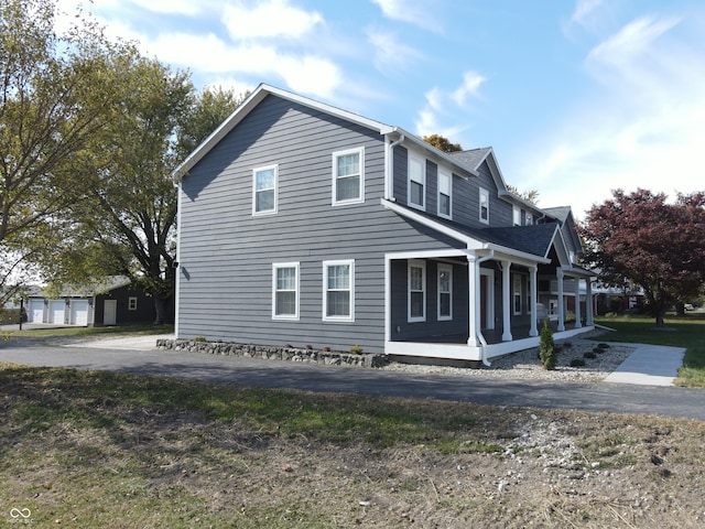 view of property exterior with a garage and a sunroom