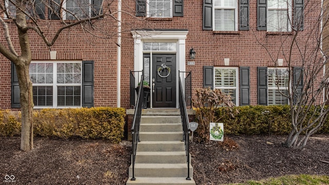 view of exterior entry with brick siding