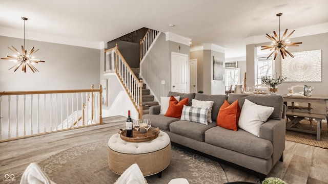 living room featuring stairs, crown molding, a notable chandelier, and wood finished floors