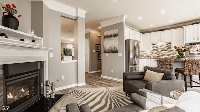 living room with light wood-type flooring, a fireplace with flush hearth, ornamental molding, recessed lighting, and baseboards