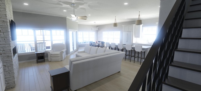 living room featuring plenty of natural light, crown molding, light hardwood / wood-style floors, and ceiling fan