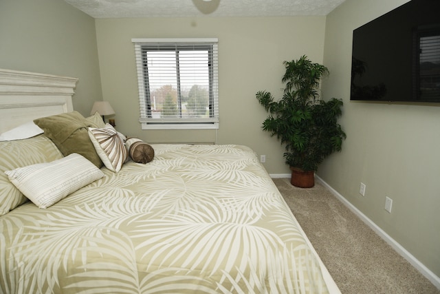 bedroom with carpet floors and a textured ceiling