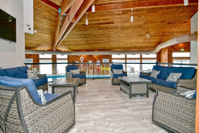 living room with light hardwood / wood-style floors, a wealth of natural light, and wood ceiling