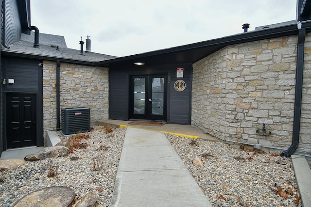 entrance to property featuring french doors and cooling unit