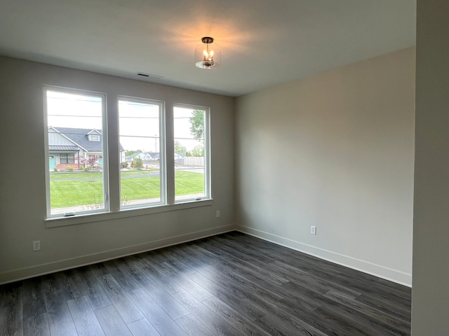 unfurnished room featuring dark hardwood / wood-style floors