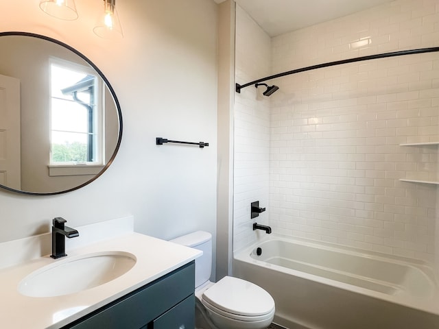 full bathroom with tiled shower / bath combo, toilet, and vanity