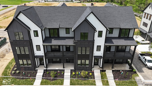 exterior space with covered porch and a balcony