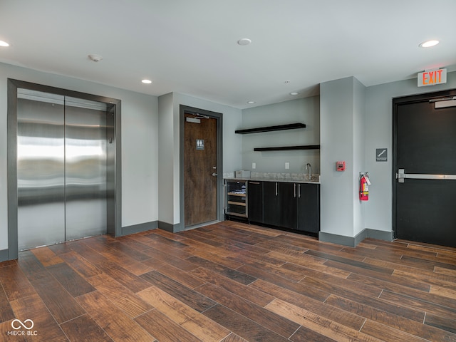 kitchen featuring elevator and dark hardwood / wood-style floors