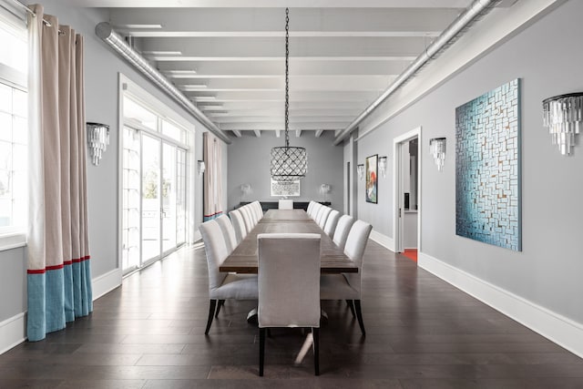 dining space featuring dark wood-style flooring, beam ceiling, and baseboards