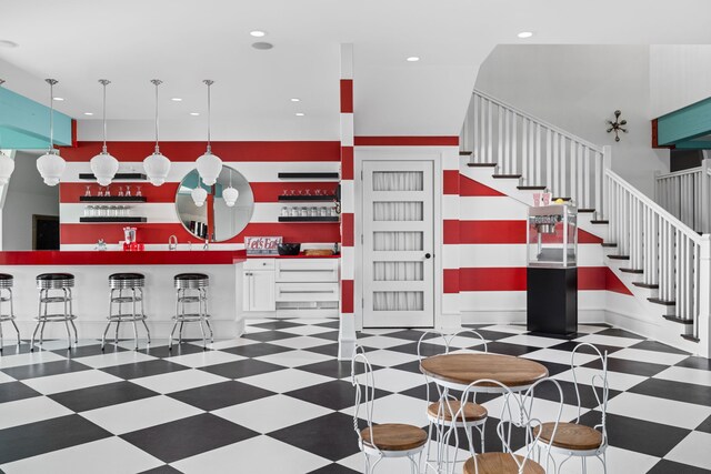 interior space with recessed lighting, indoor wet bar, and tile patterned floors