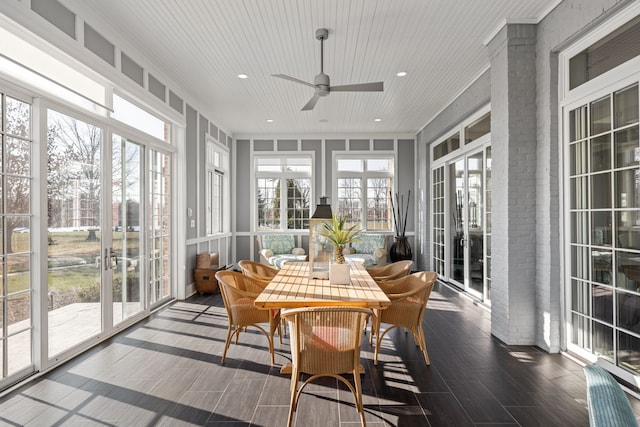 sunroom / solarium with a ceiling fan