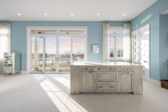 bar with light colored carpet, a healthy amount of sunlight, and recessed lighting