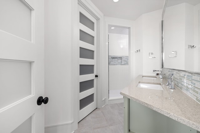 bathroom with tasteful backsplash, a stall shower, vanity, and tile patterned floors