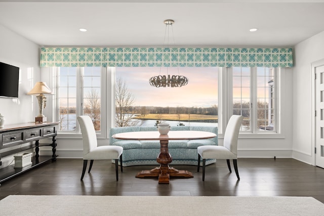 dining area with hardwood / wood-style flooring and baseboards