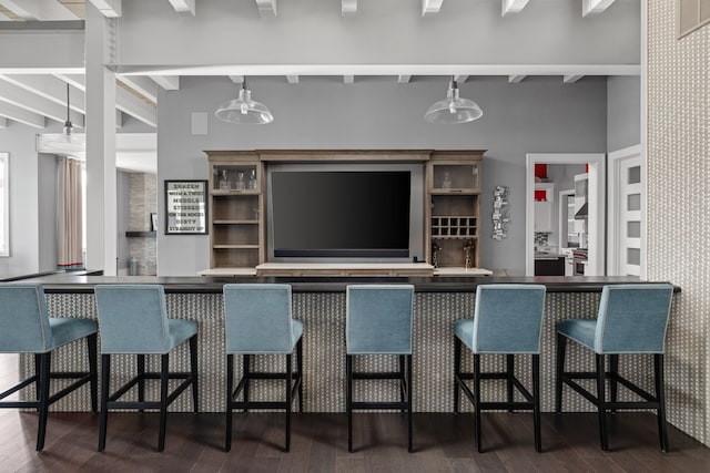 kitchen featuring hardwood / wood-style flooring, a high ceiling, visible vents, and beam ceiling