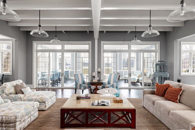 living area featuring beam ceiling and wood finished floors