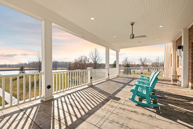 patio terrace at dusk featuring ceiling fan