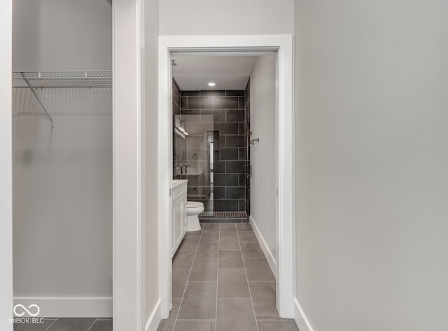 bathroom featuring vanity, tile patterned floors, and walk in shower