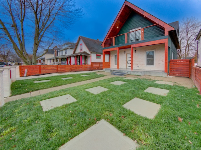 view of front of house with a porch and a front lawn