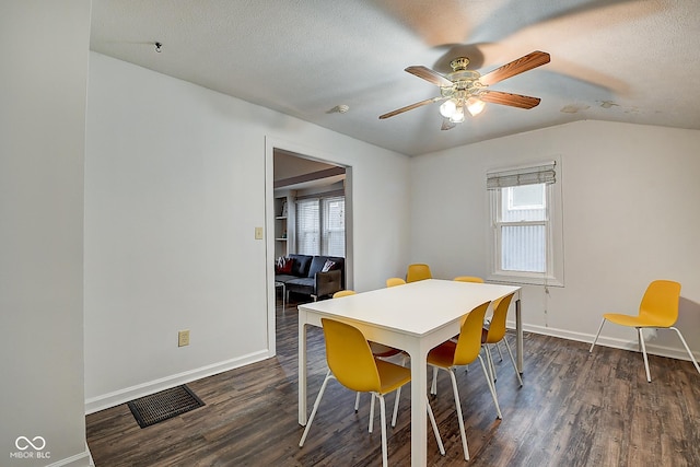 dining room featuring a textured ceiling, dark wood finished floors, visible vents, and baseboards