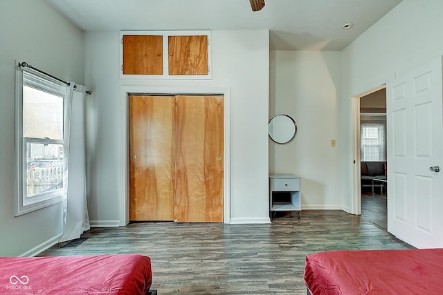 bedroom with baseboards and wood finished floors