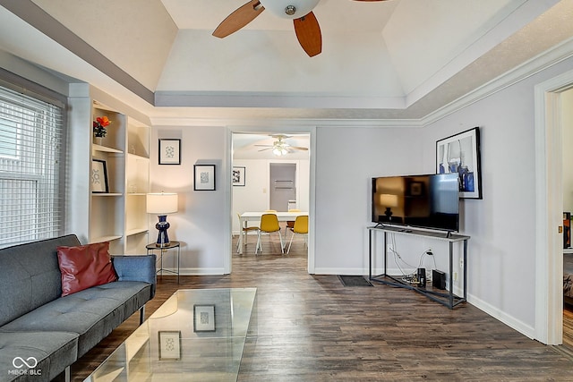 living area with built in shelves, lofted ceiling, dark wood finished floors, and a ceiling fan