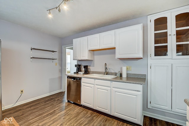 kitchen featuring dishwasher, a sink, dark wood finished floors, and white cabinetry