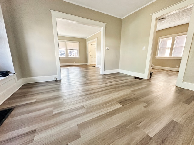 unfurnished room with ornamental molding and light hardwood / wood-style floors