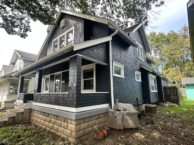 view of property exterior with central AC unit and a porch