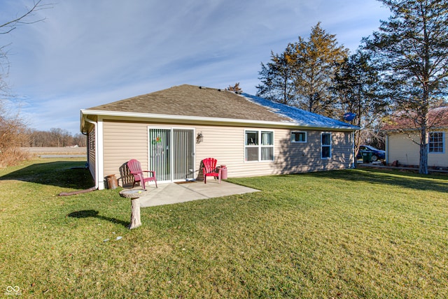 rear view of house with a lawn and a patio