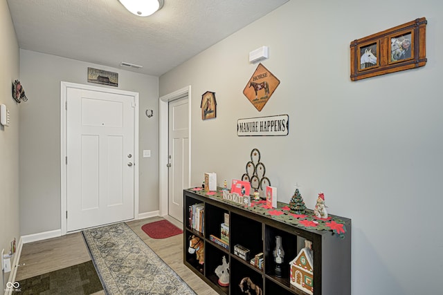 310 Jefferson, Coatesville, IN 46121 - entrance foyer with wood finished floors, baseboards, and a textured ceiling