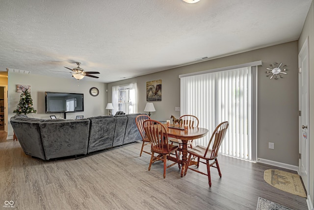 310 Jefferson, Coatesville, IN 46121 - dining area with wood finished floors, a textured ceiling, a ceiling fan, and baseboards