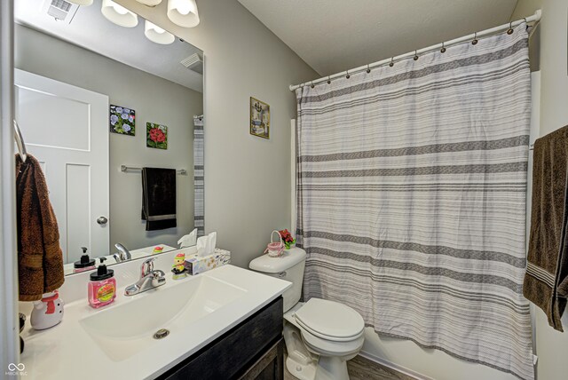 310 Jefferson, Coatesville, IN 46121 - bathroom featuring vanity, toilet, and shower / bathtub combination with curtain