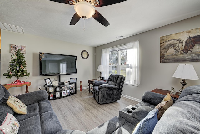 310 Jefferson, Coatesville, IN 46121 - living area with a ceiling fan, wood finished floors, and baseboards
